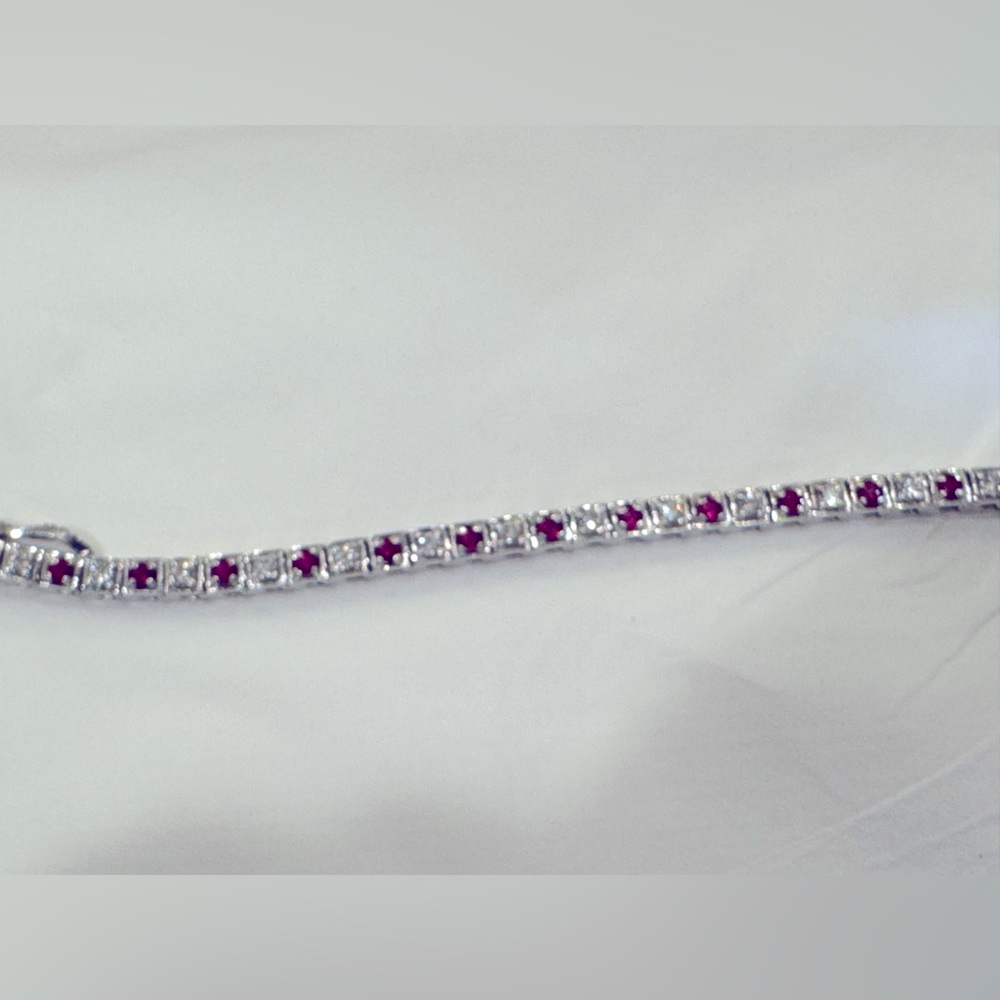 Diamond and ruby tennis bracelet set in 18kt white gold.